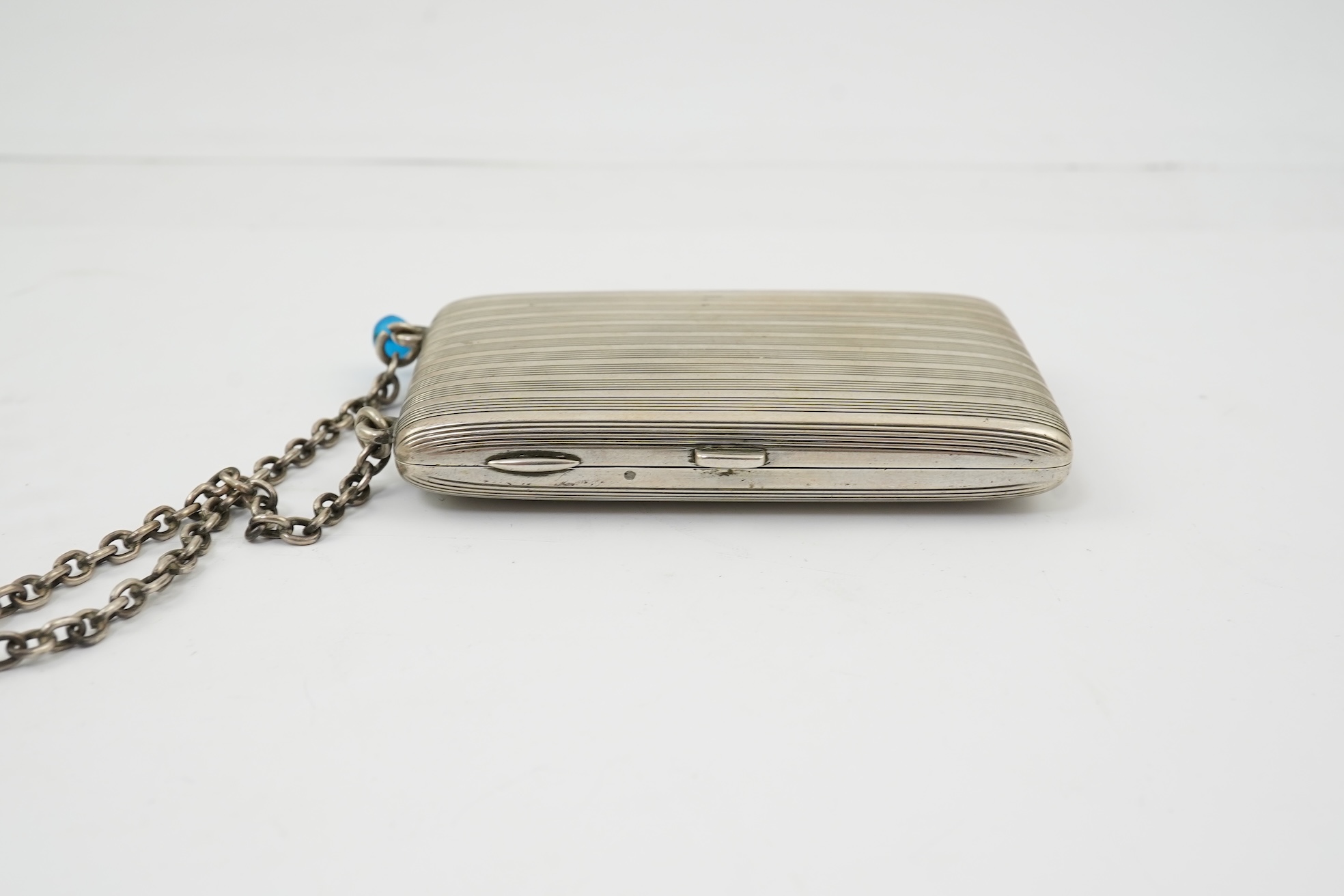 An early 20th century continental 800 standard silver combination, card, coin, aide memoir and pill case, with pencil and ribbed decoration, maker WK